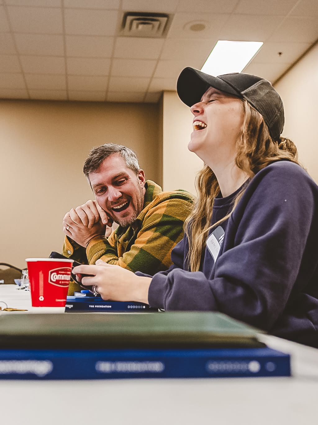 A couple laughing together during a Highland Marriage Ministry session